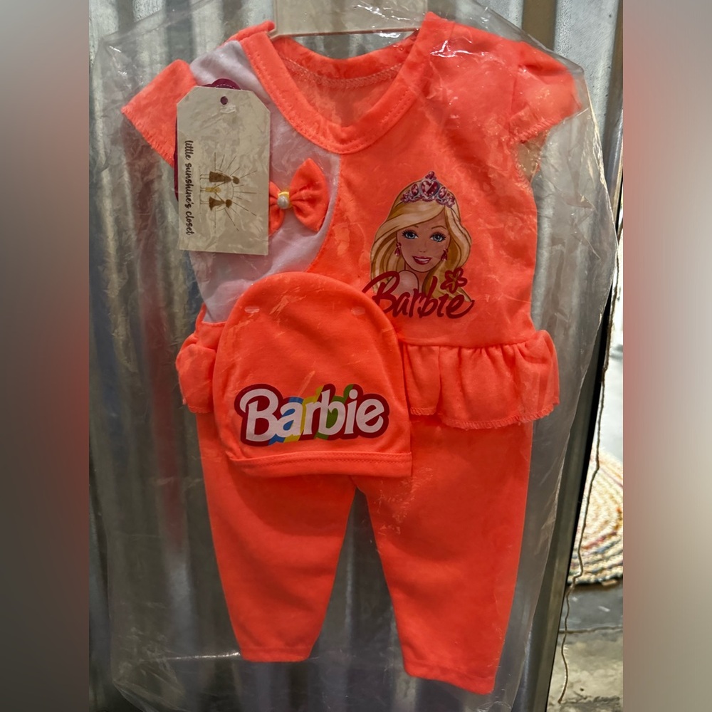 Beautiful pink Barbie outfit. Comes with top bottom and a hat. Size 0-3 months.